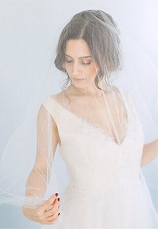 women in wedding gown with veil